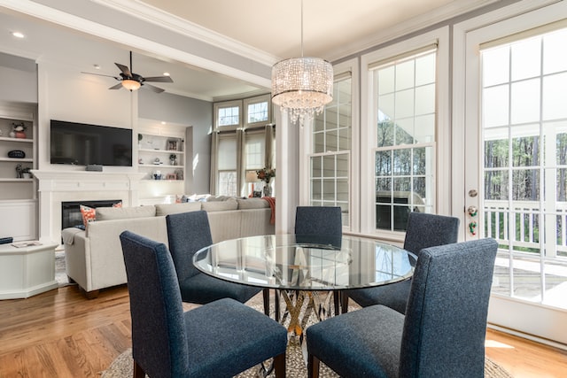 Interior of a modern home with a round glass dining table and grey chairs